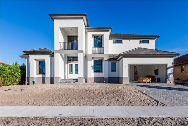 view of front of home with a balcony and a garage