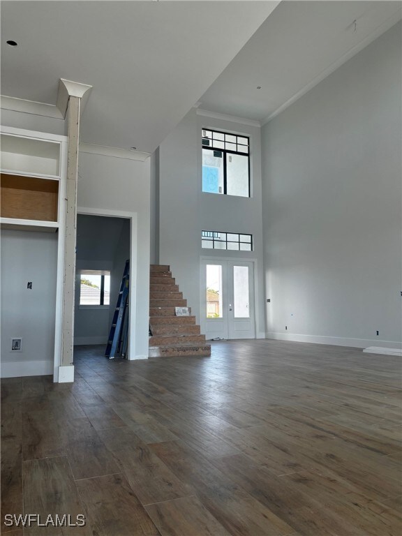 interior space with french doors, dark hardwood / wood-style floors, and crown molding