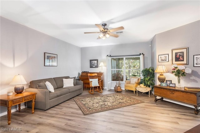 living room with ceiling fan and light hardwood / wood-style floors