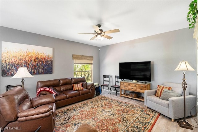 living room featuring light hardwood / wood-style flooring and ceiling fan