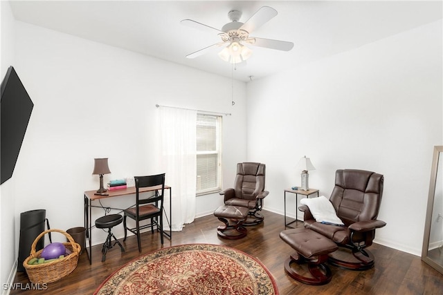 living area featuring ceiling fan and dark hardwood / wood-style floors