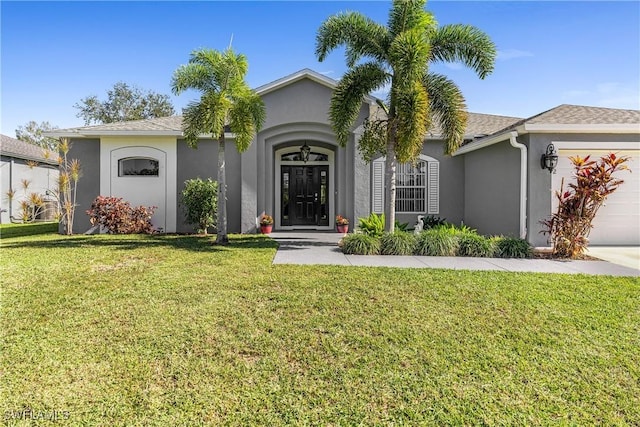 ranch-style home with a front yard and a garage