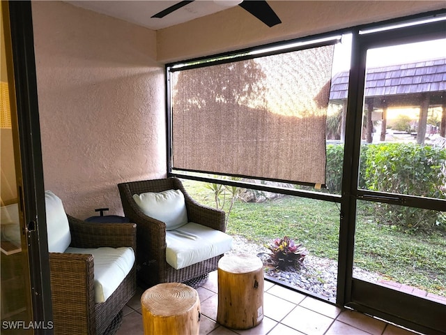 unfurnished sunroom with ceiling fan