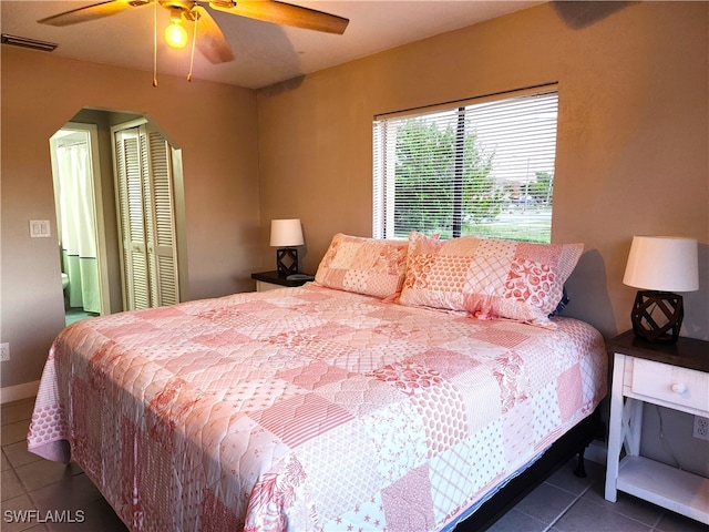 tiled bedroom with ceiling fan