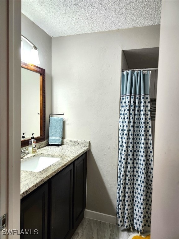 bathroom featuring vanity and a textured ceiling