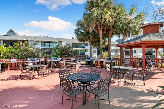 wooden deck featuring a gazebo and a grill