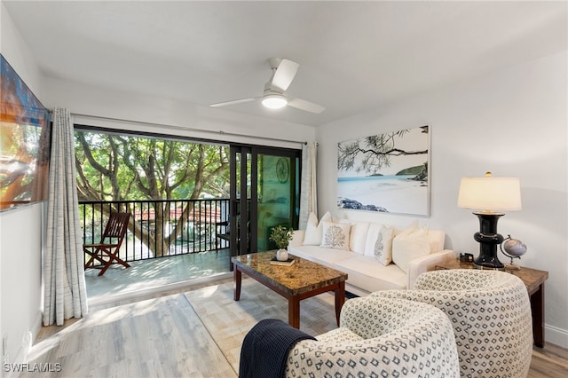 living room featuring light wood-type flooring and ceiling fan