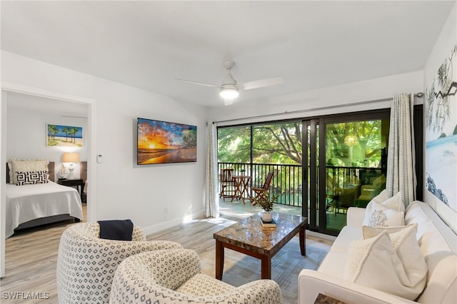 living room featuring ceiling fan and light hardwood / wood-style floors