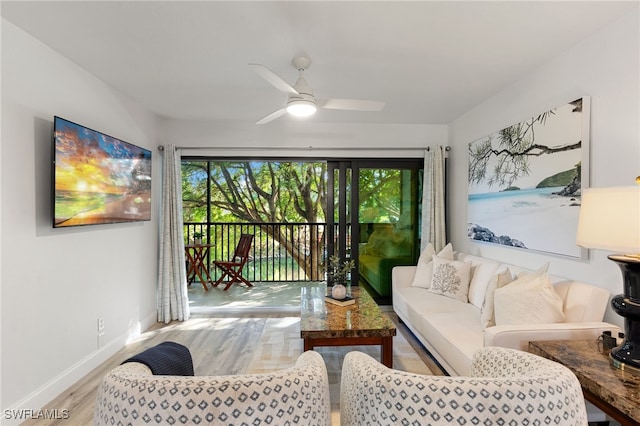 living room featuring ceiling fan and light hardwood / wood-style floors