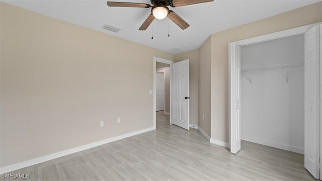 unfurnished bedroom featuring a closet, light hardwood / wood-style floors, and ceiling fan