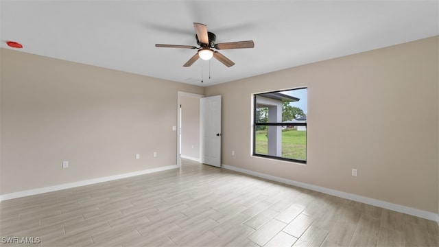 spare room featuring ceiling fan and light hardwood / wood-style floors