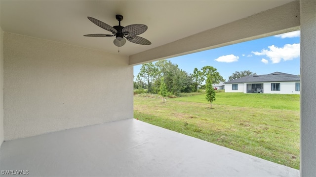 view of yard featuring ceiling fan and a patio area