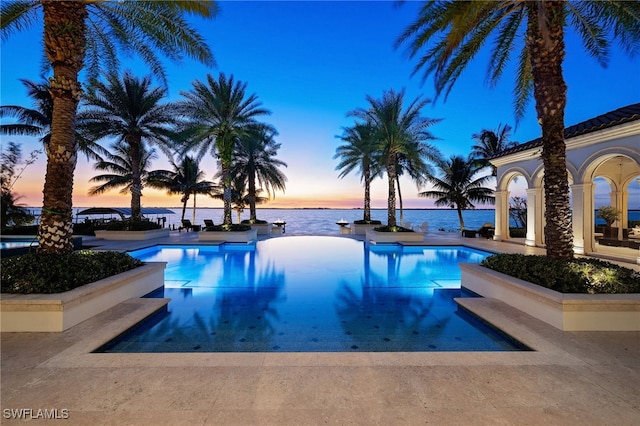 pool at dusk with a water view