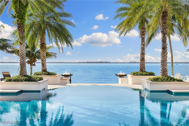 view of swimming pool with a water view