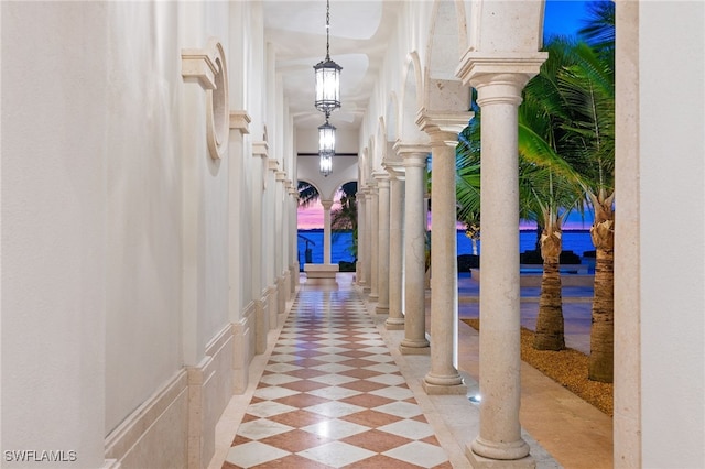 hall featuring decorative columns