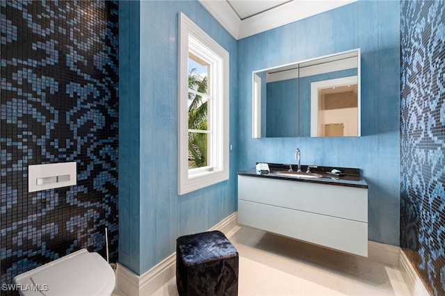 bathroom featuring crown molding, vanity, and toilet