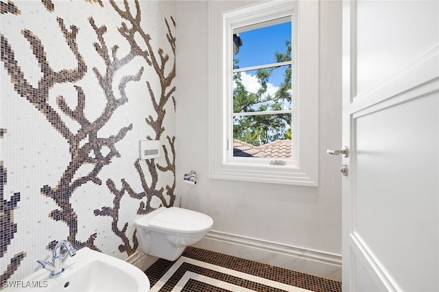 bathroom featuring tile patterned floors, toilet, and sink