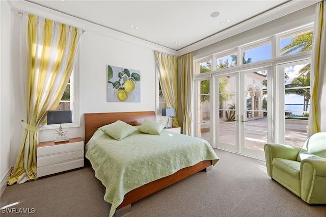 bedroom with crown molding, carpet, and access to outside