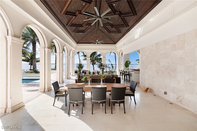 interior space featuring ornate columns, a towering ceiling, coffered ceiling, wooden ceiling, and beam ceiling