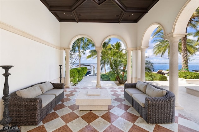 view of patio / terrace with a water view and outdoor lounge area