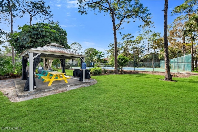 view of yard with a gazebo and tennis court