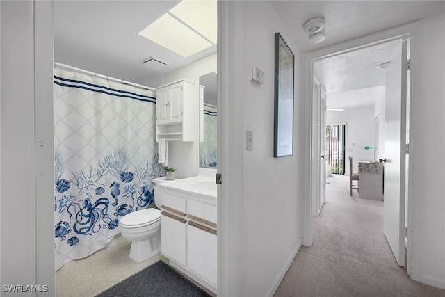 bathroom featuring vanity, a shower with shower curtain, and toilet