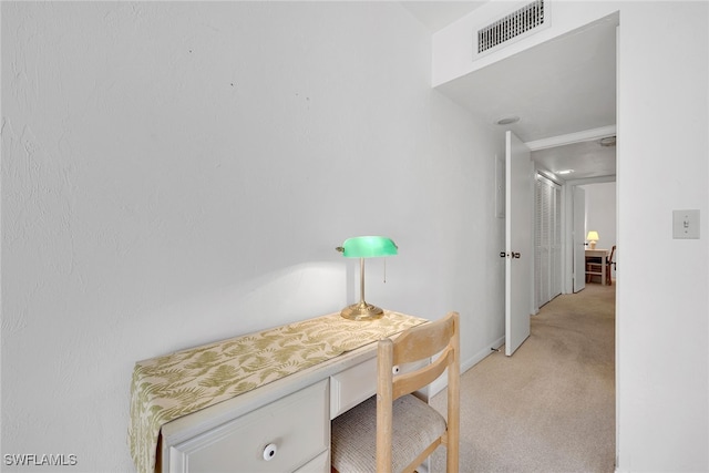 interior space featuring light colored carpet and built in desk