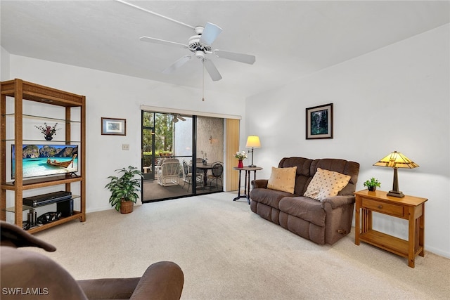 living room featuring ceiling fan and carpet