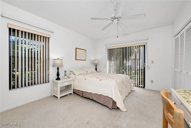 carpeted bedroom featuring multiple windows, a closet, and ceiling fan