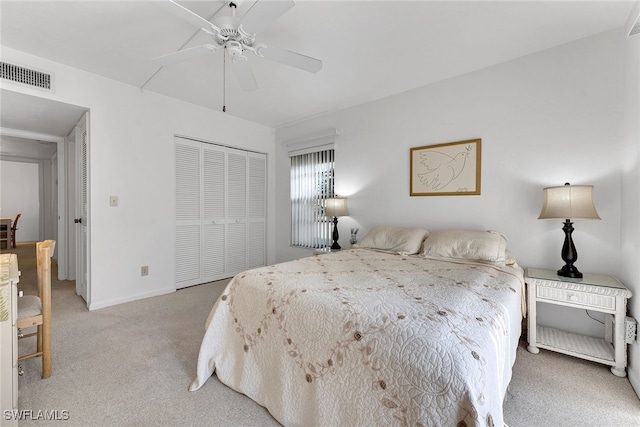 carpeted bedroom featuring a closet and ceiling fan