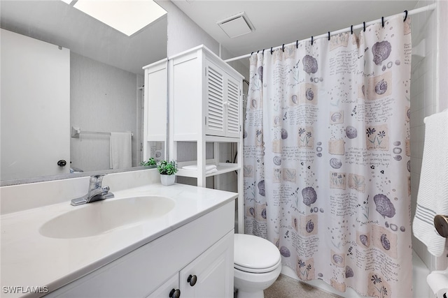 bathroom featuring vanity, toilet, and walk in shower