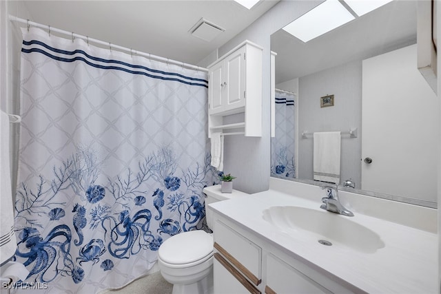 bathroom featuring a shower with shower curtain, vanity, a skylight, and toilet