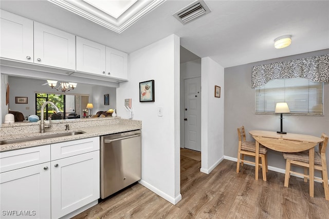 kitchen featuring sink, stainless steel dishwasher, a notable chandelier, light hardwood / wood-style floors, and white cabinets