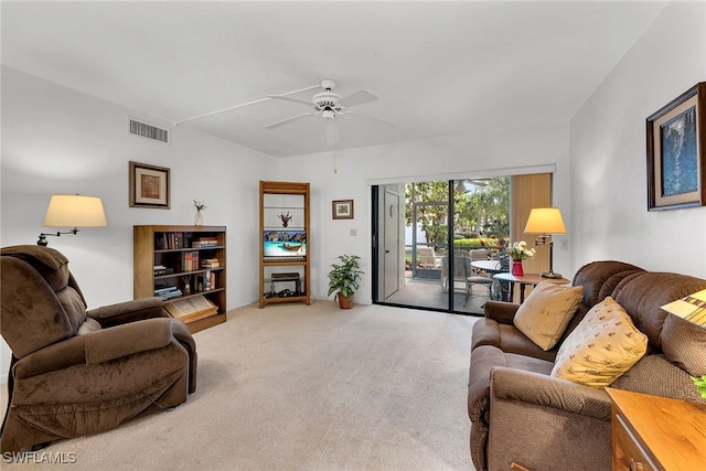 carpeted living room with ceiling fan