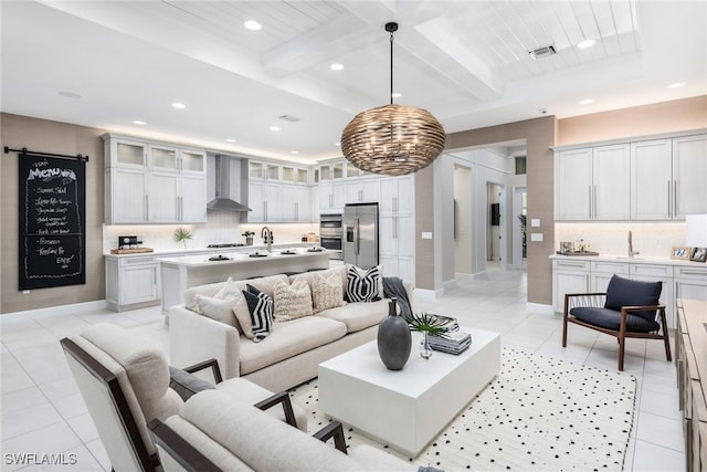 tiled living room with beamed ceiling and sink