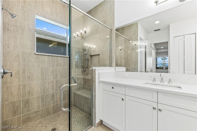 bathroom featuring vanity and an enclosed shower