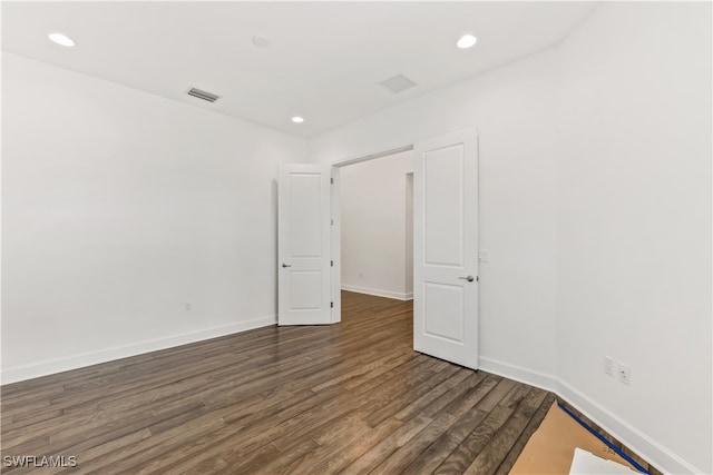 spare room with dark wood-type flooring