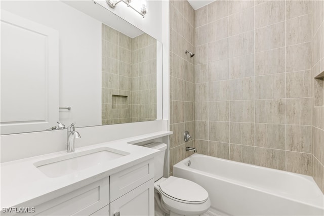 full bathroom featuring vanity, toilet, and tiled shower / bath