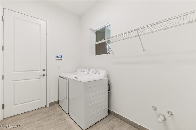 washroom featuring light hardwood / wood-style flooring and independent washer and dryer