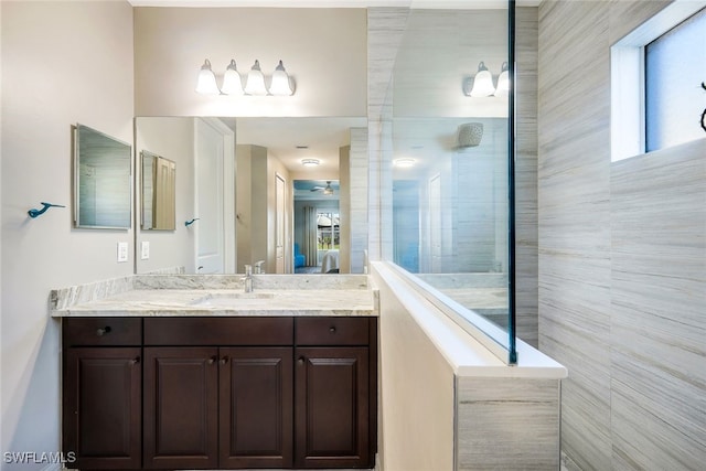 bathroom with vanity and tiled shower