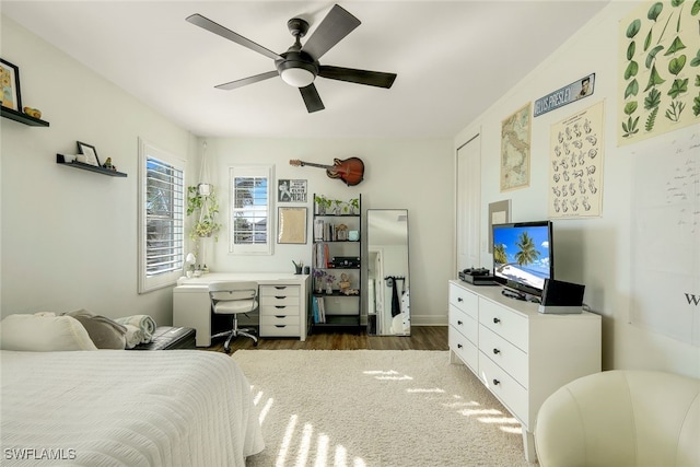 bedroom with ceiling fan and dark wood-type flooring