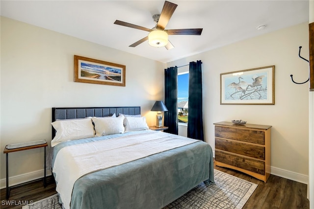 bedroom with dark hardwood / wood-style flooring and ceiling fan