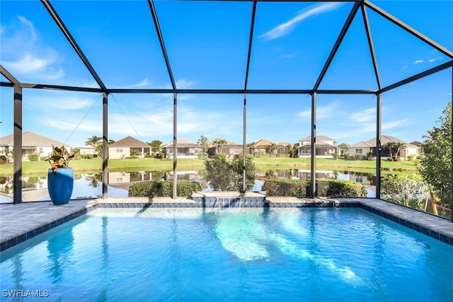 view of swimming pool with a lanai, a patio, and a water view