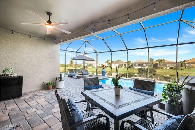 view of patio / terrace with glass enclosure and ceiling fan