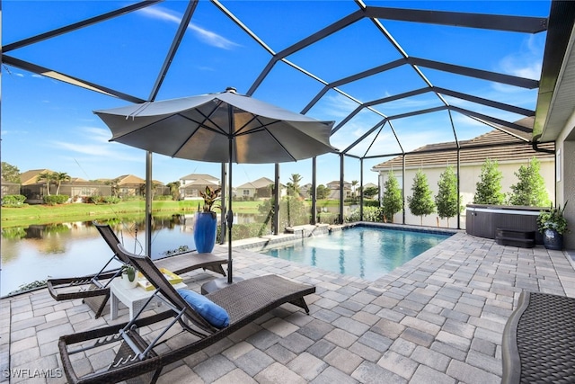 view of pool featuring a lanai, a patio area, a water view, and a hot tub