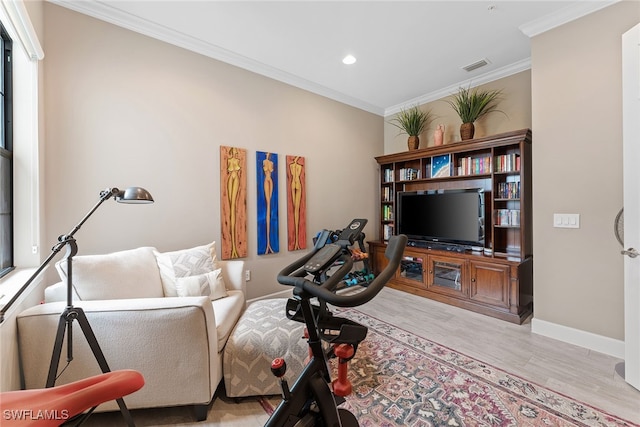 sitting room featuring crown molding and light wood-type flooring