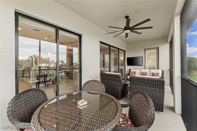 sunroom featuring a wealth of natural light and ceiling fan