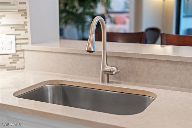 room details featuring tasteful backsplash and sink