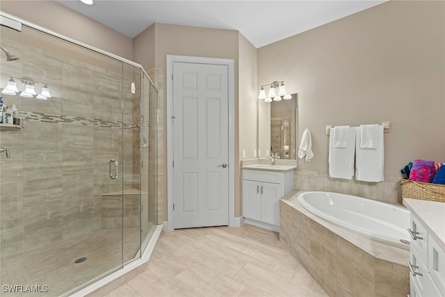 bathroom with separate shower and tub, tile patterned floors, and vanity