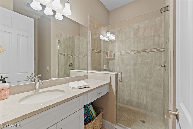 bathroom featuring vanity and an enclosed shower